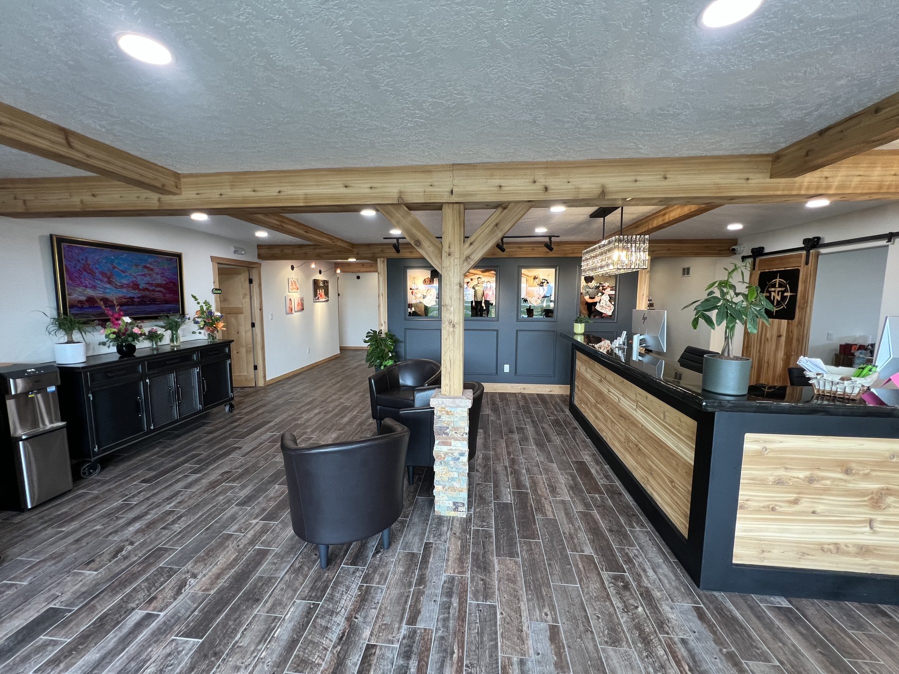Waiting room with leather chairs and water station at True North Chiropractic